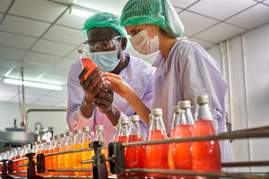 Man and woman performing sensory testing of beverages